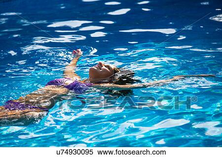 Stock Photography - Woman doing backstroke in swimming pool. Fotosearch