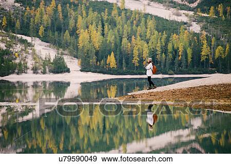 Stock Photo - Woman enjoying view, Lago di Braies, Dolomite Alps, Val di Braies, South Tyrol, Italy. Fotosearch