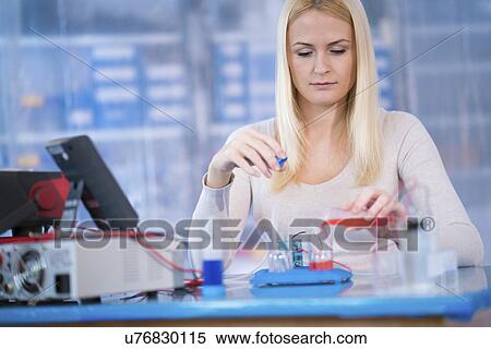 Stock Photography - Woman experimenting with fuel cell. Fotosearch