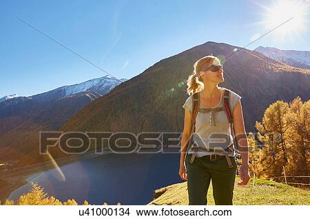 Picture - Woman hiking, looking at view, Schnalstal, South Tyrol, Italy. Fotosearch
