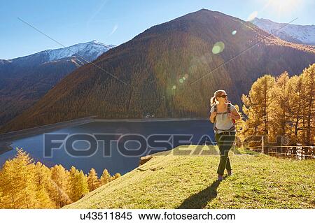 Stock Photography - Woman hiking, looking at view, Schnalstal, South Tyrol, Italy. Fotosearch