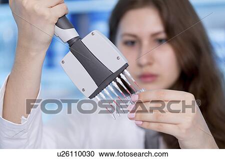 Woman holding multipipette View Large Photo Image Stock Image - Woman holding multipipette. Fotosearch