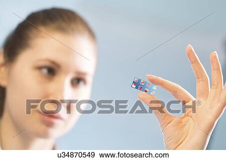 Stock Photo - Woman holding slide with blood samples. Fotosearch