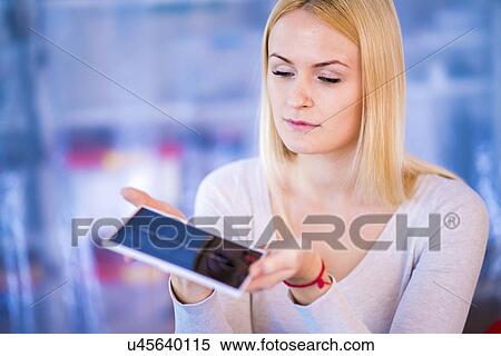 Stock Photography - Woman holding solar photovoltaic cell. Fotosearch