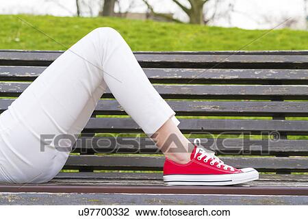 Woman lying on a bench wearing red pumps View Large Photo Image Stock Image - Woman lying on a bench wearing red pumps. Fotosearch