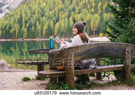 Woman relaxing on park bench, Lago di Braies, Dolomite Alps, Val di Braies, South Tyrol, Italy View Large Photo Image Stock Photo - Woman relaxing on park bench, Lago di Braies, Dolomite Alps, Val di Braies, South Tyrol, Italy. Fotosearch
