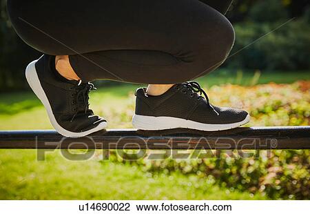 Woman training, legs and feet balancing on park fence View Large Photo Image Stock Image - Woman training, legs and feet balancing on park fence. Fotosearch