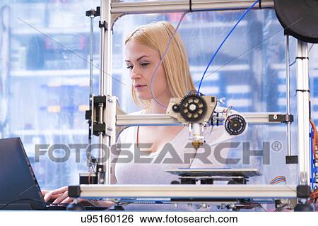 Stock Photograph - Woman using 3d printer. Fotosearch