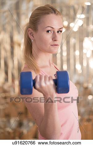 Woman using hand weight View Large Photo Image Stock Photograph - Woman using hand weight. Fotosearch