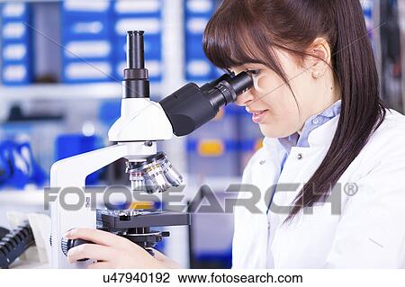Woman using microscope View Large Photo Image Stock Image - Woman using microscope. Fotosearch