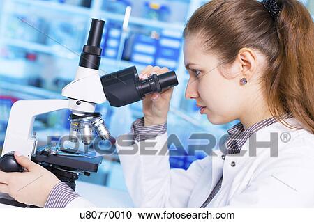 Woman using microscope View Large Photo Image Stock Image - Woman using microscope. Fotosearch