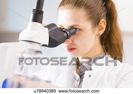 Woman using microscope View Large Photo Image Stock Photo - Woman using microscope. Fotosearch
