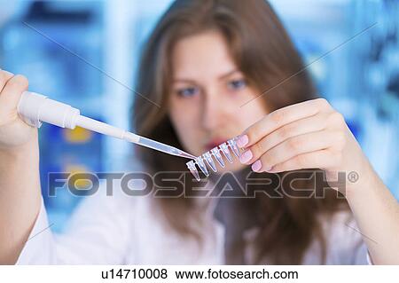 Stock Photo - Woman using pipette. Fotosearch