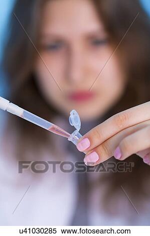 Woman using pipette View Large Photo Image Stock Photography - Woman using pipette. Fotosearch