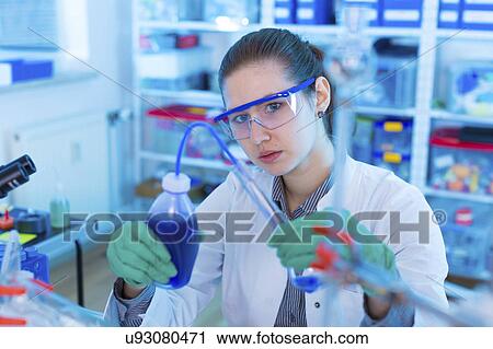Stock Image - Woman working in chemical laboratory. Fotosearch