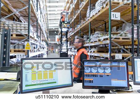 Stock Image - Worker in cable store warehouse at cable storage facility. Fotosearch