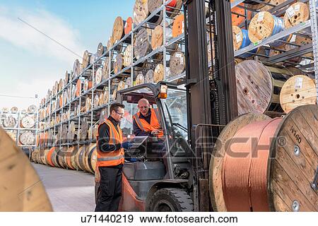 Workers with fork lift truck at cable storage facility View Large Photo Image Stock Photo - Workers with fork lift truck at cable storage facility. Fotosearch
