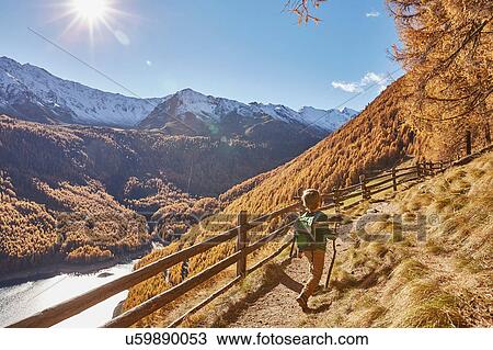 Young boy hiking along pathway, rear view, Schnalstal, South Tyrol, Italy View Large Photo Image Stock Image - Young boy hiking along pathway, rear view, Schnalstal, South Tyrol, Italy. Fotosearch