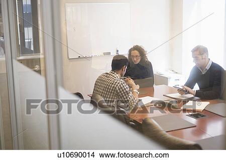 Picture - Young business people having meeting in board room. Fotosearch