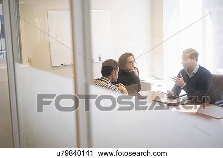 Young business people having meeting in board room View Large Photo Image Stock Image - Young business people having meeting in board room. Fotosearch