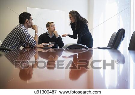 Young business people having meeting in board room View Large Photo Image Stock Photo - Young business people having meeting in board room. Fotosearch
