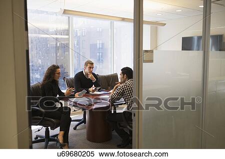 Young business people having meeting in conference room View Large Photo Image Stock Photography - Young business people having meeting in conference room. Fotosearch