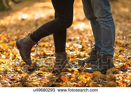 Stock Image - Young couple in forest, face to face, low section. Fotosearch