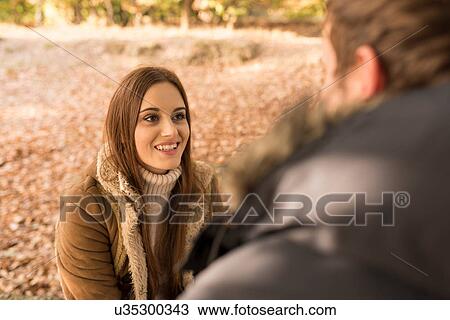 Young couple in park together, face to face, smiling View Large Photo Image Stock Image - Young couple in park together, face to face, smiling. Fotosearch