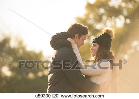 Young couple in rural setting, face to face, smiling View Large Photo Image Stock Image - Young couple in rural setting, face to face, smiling. Fotosearch
