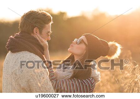 Young couple in rural setting, fooling around, face to face View Large Photo Image Stock Photo - Young couple in rural setting, fooling around, face to face. Fotosearch