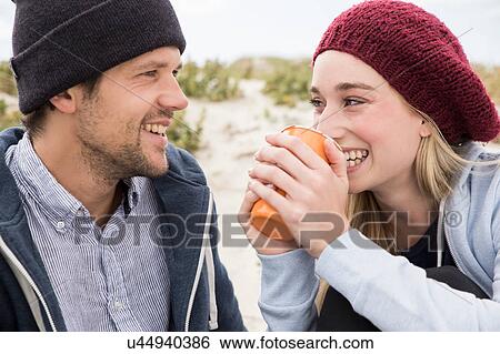 Stock Photograph - Young couple picnicking on beach, Western Cape, South Africa. Fotosearch
