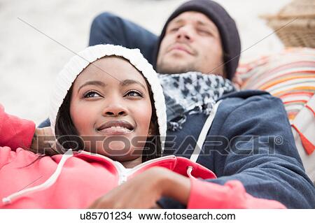 Young couple reclining on picnic blanket at beach, Western Cape, South Africa View Large Photo Image Picture - Young couple reclining on picnic blanket at beach, Western Cape, South Africa. Fotosearch