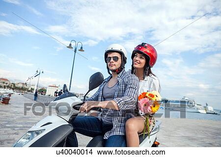 Picture - Young couple riding moped at harbour, Split, Dalmatia, Croatia. Fotosearch