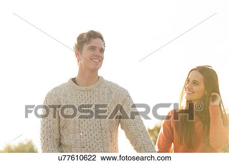 Young couple walking in rural setting View Large Photo Image Stock Image - Young couple walking in rural setting. Fotosearch