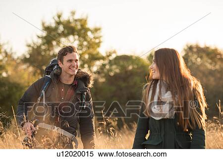 Young couple walking through field View Large Photo Image Stock Photography - Young couple walking through field. Fotosearch