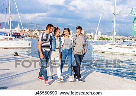 Young couples strolling on harbour, Split, Dalmatia, Croatia View Large Photo Image Stock Image - Young couples strolling on harbour, Split, Dalmatia, Croatia. Fotosearch