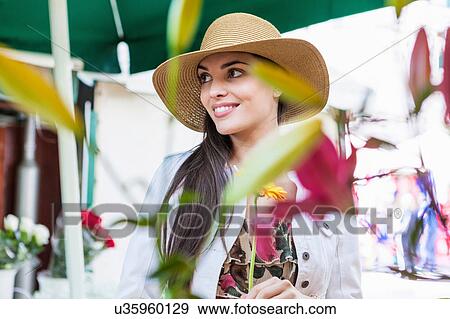 Stock Photo - Young female tourist at flower market stall, Split, Dalmatia, Croatia. Fotosearch