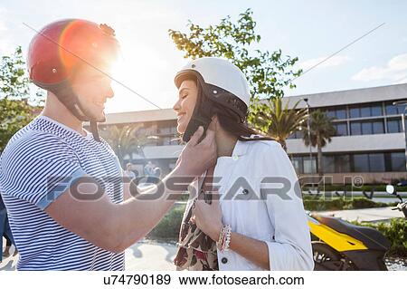 Young man fastening girlfriend's crash helmet, Split, Dalmatia, Croatia View Large Photo Image Stock Photo - Young man fastening girlfriend's crash helmet, Split, Dalmatia, Croatia. Fotosearch