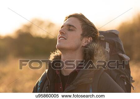 Young man in rural setting, carefree expression View Large Photo Image Stock Photography - Young man in rural setting, carefree expression. Fotosearch