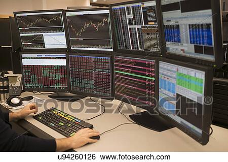 Young man working on group of computer monitors View Large Photo Image Stock Photograph - Young man working on group of computer monitors. Fotosearch