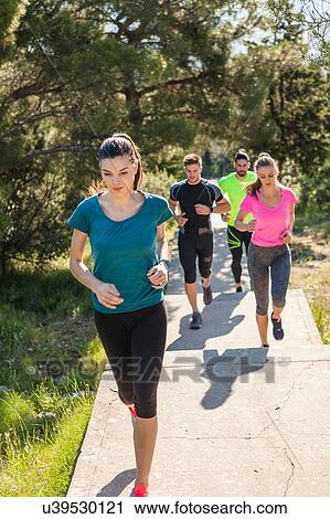 Young men and women running in park, Split, Dalmatia, Croatia View Large Photo Image Stock Image - Young men and women running in park, Split, Dalmatia, Croatia. Fotosearch