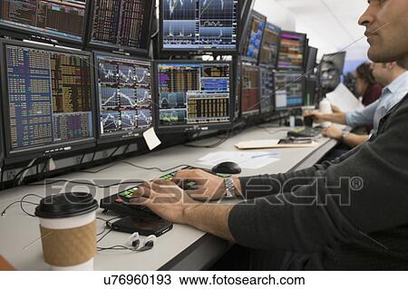 Stock Image - Young trader typing on computer. Fotosearch