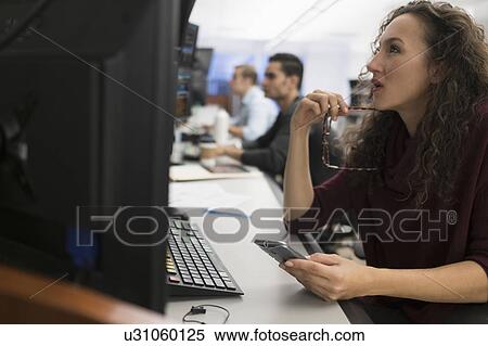 Young trader using mobile phone View Large Photo Image Stock Photography - Young trader using mobile phone. Fotosearch