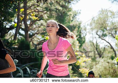 Young woman and team running through park, Split, Dalmatia, Croatia View Large Photo Image Stock Image - Young woman and team running through park, Split, Dalmatia, Croatia. Fotosearch