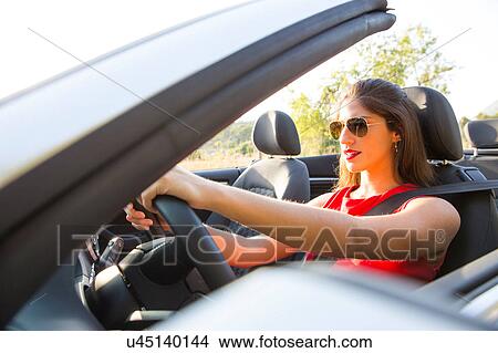 Young woman driving on rural road in convertible, Majorca, Spain View Large Photo Image Picture - Young woman driving on rural road in convertible, Majorca, Spain. Fotosearch