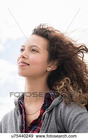 Young woman gazing from windy beach, Western Cape, South Africa View Large Photo Image Stock Photo - Young woman gazing from windy beach, Western Cape, South Africa. Fotosearch