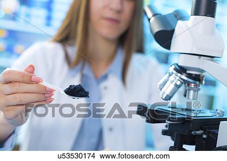 Picture - Young woman in food quality control laboratory. Fotosearch