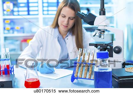 Stock Photography - Young woman in food quality control laboratory. Fotosearch