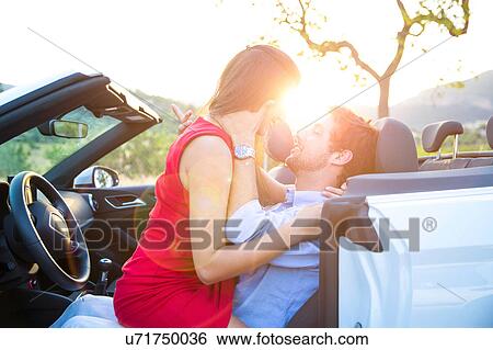Young woman straddling boyfriend in convertible front seat at sunset, Majorca, Spain View Large Photo Image Stock Photograph - Young woman straddling boyfriend in convertible front seat at sunset, Majorca, Spain. Fotosearch