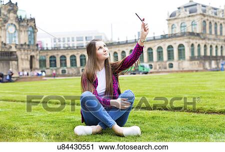 Young woman taking photo of herself View Large Photo Image Stock Image - Young woman taking photo of herself. Fotosearch